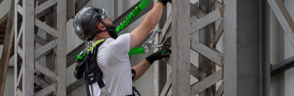 man working at height with helmet and harness on