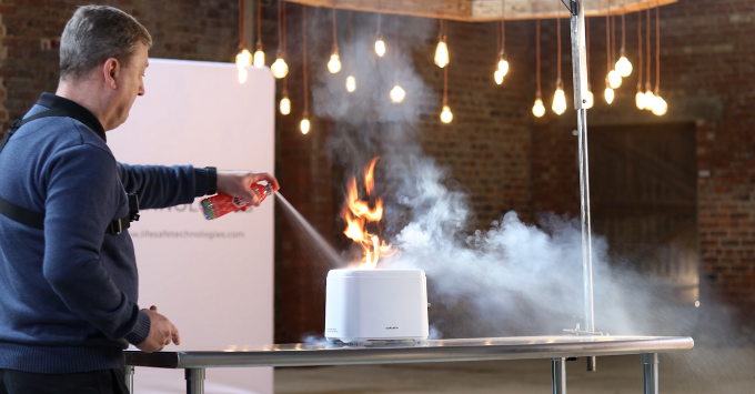 Man using LifeSafe 5-in-1 Extinguisher to put out toaster fire
