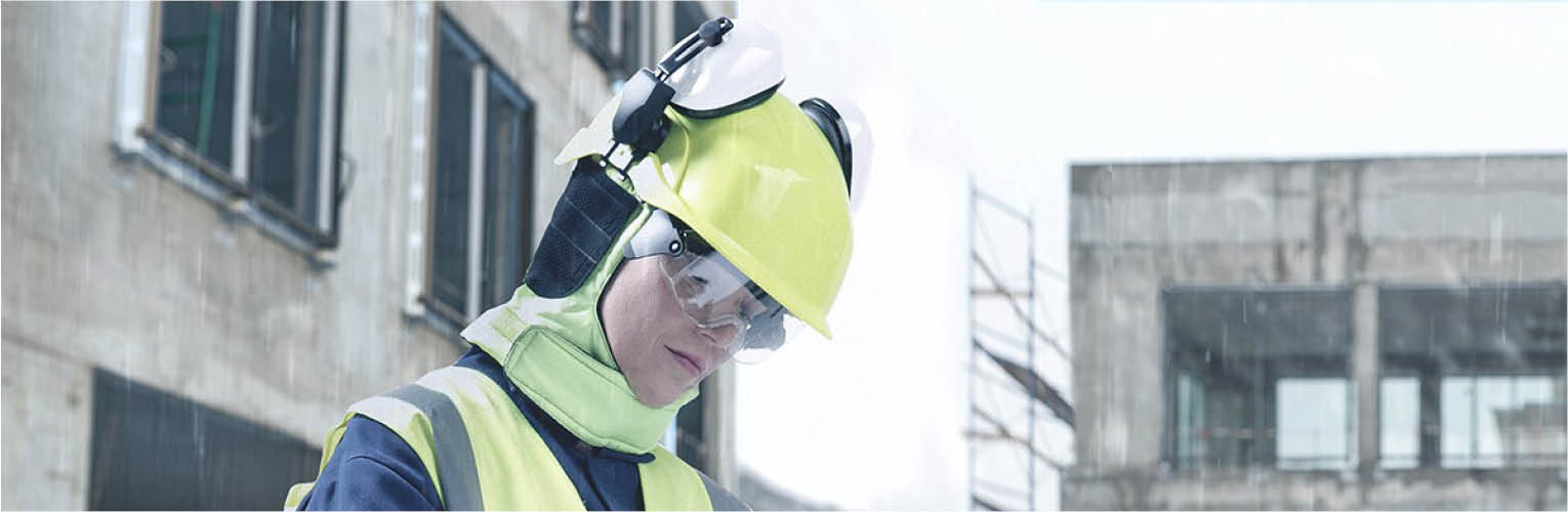 Woman wearing a safety helmet and frost cape
