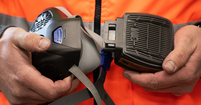 Man changing a filter in a respirator
