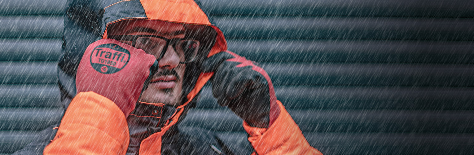 Man wearing safety goggles and gloves in the rain