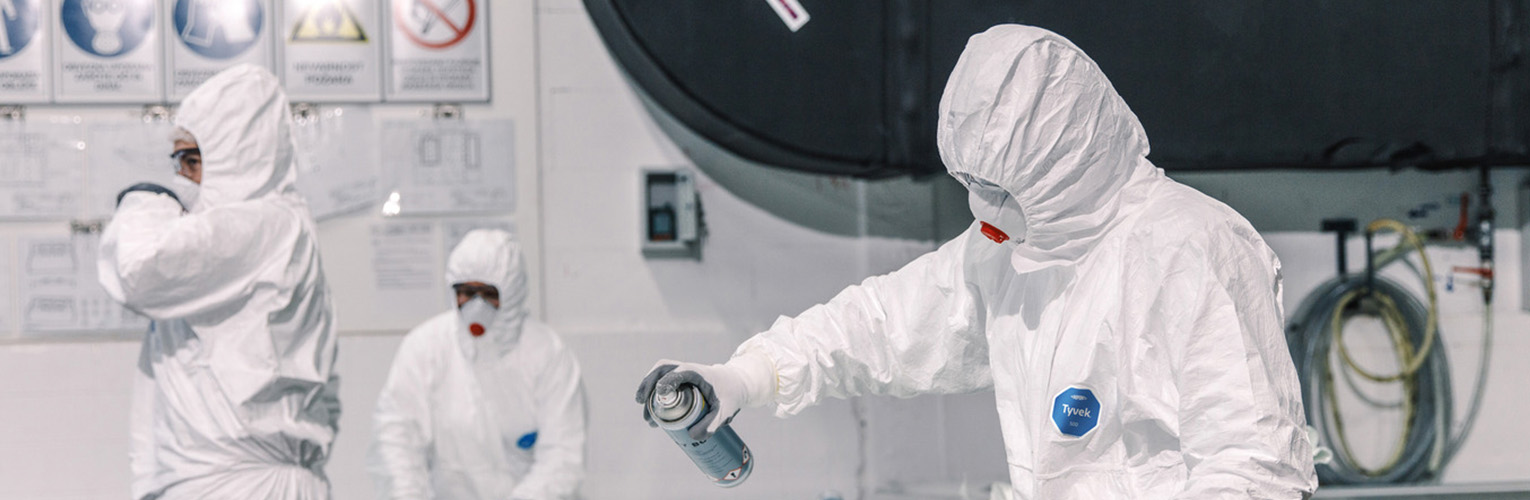 People wearing protective coveralls