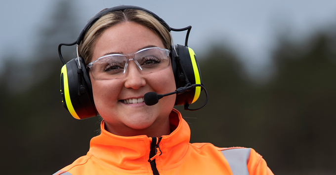 Woman hearing PPE and a headset