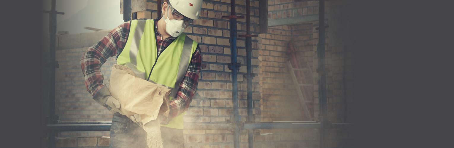 A man pouring dust in PPE