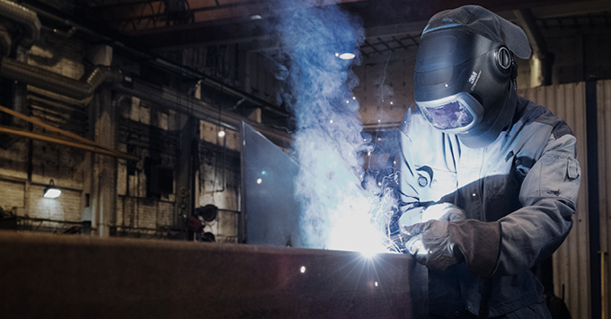 A man welding wearing PPE