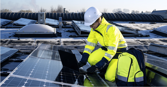 a lady in PPE working on solar panels 