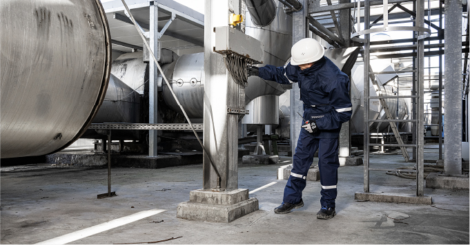 A man wearing PPE in a factory